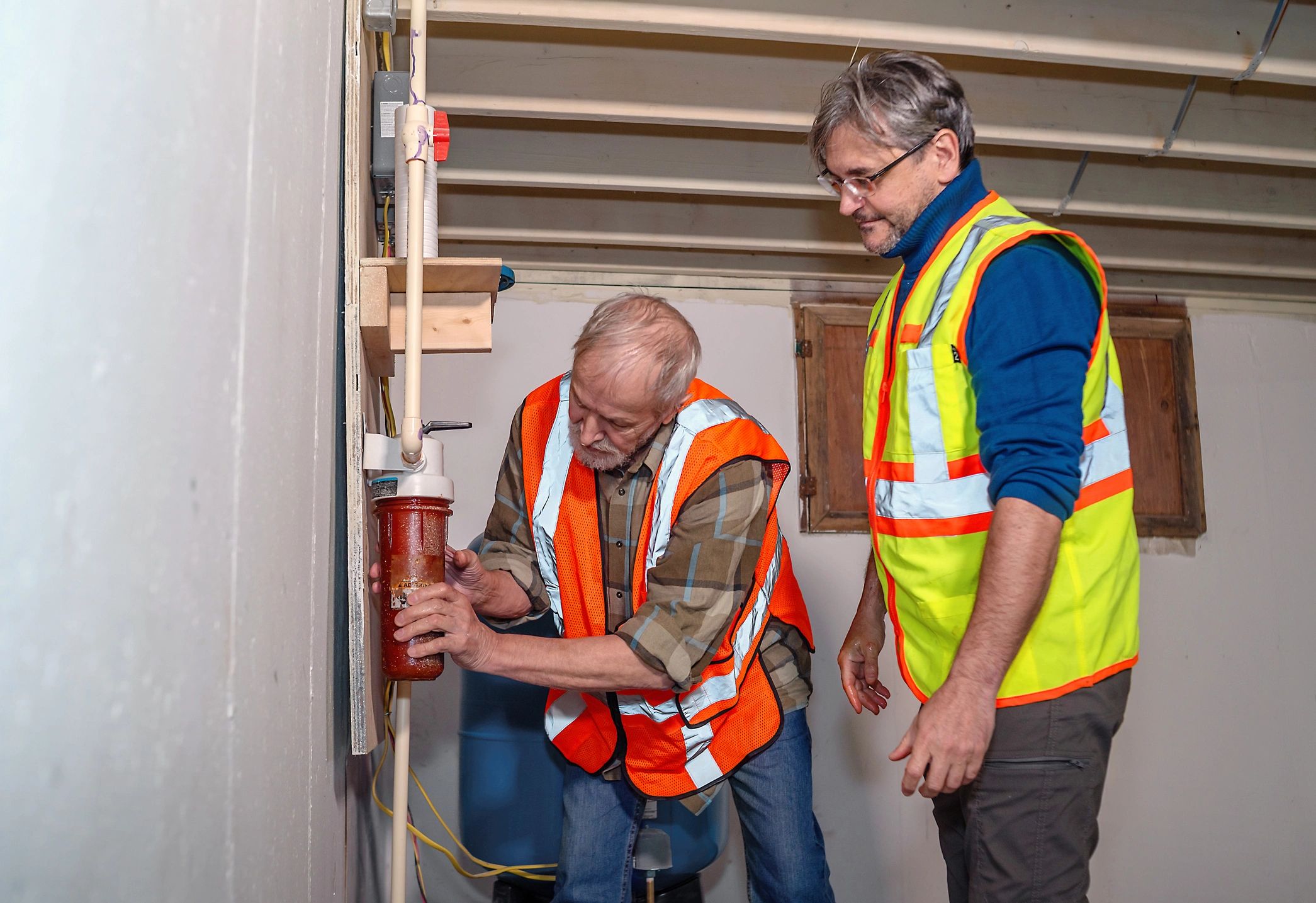 Contractors inspecting a residential home system with care